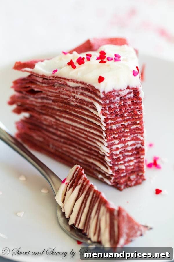 Crimson Velvet Crepe Creation 4 Close-up of a slice of Red Velvet Crepe Cake showcasing glorious layers and cream cheese filling.