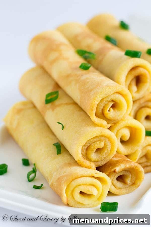 Freshly grated extra sharp cheddar cheese, a key ingredient for the savory crepe batter, highlighting its texture and quality.