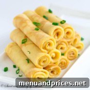A delicious savory cheese crepe, folded or rolled, showcasing its golden-brown color and inviting texture.