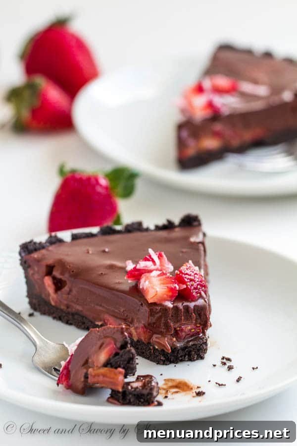 Decadent Chocolate Dream Tart 6 A beautifully decorated no-bake chocolate truffle tart with strawberries and coconut, ready to be enjoyed.