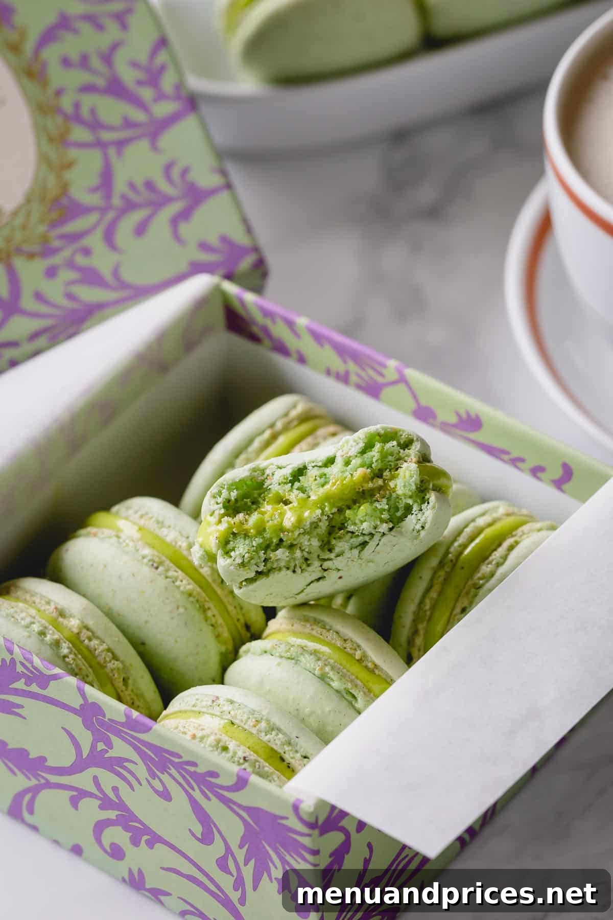 Heavenly Pistachio Macarons 2 Exquisitely arranged pistachio macarons in a elegant box, showcasing their vibrant green color and perfect 'feet'.