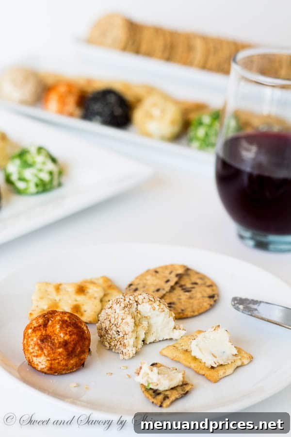 Bite-Sized Cheesy Delights 6 A guest's hand gracefully reaching for an individual mini cheese ball from a well-arranged appetizer platter, emphasizing the ease of serving and the attractive presentation alongside various crackers and garnishes.