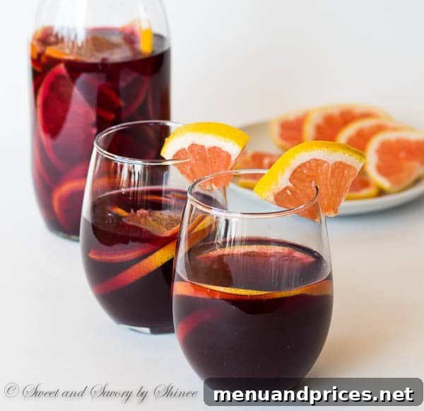 Zesty Grapefruit Sangria 2 A vibrant glass of grapefruit red sangria, garnished with fresh citrus slices, perfect for a summer BBQ.
