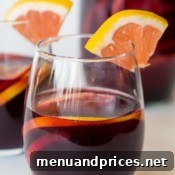 Grapefruit sangria served in elegant wine glasses with fresh fruit slices.