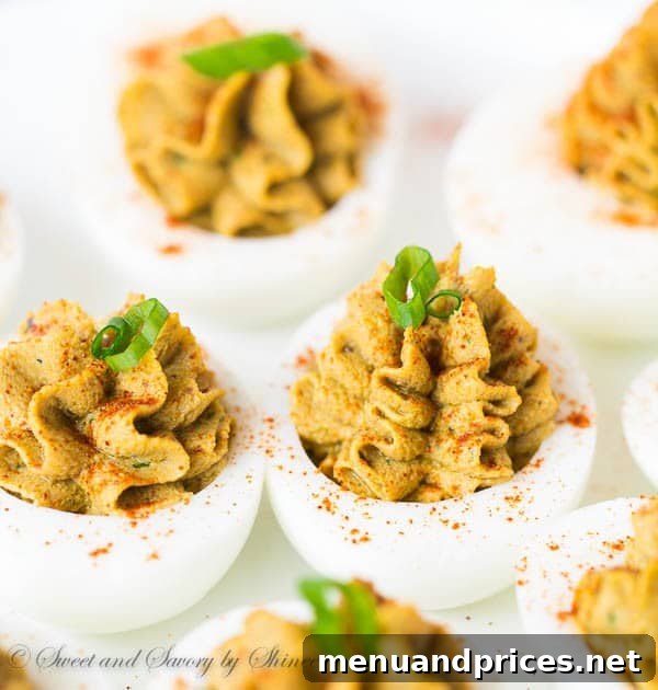 Plated gourmet chicken liver pate deviled eggs, ready to serve as an impressive appetizer.