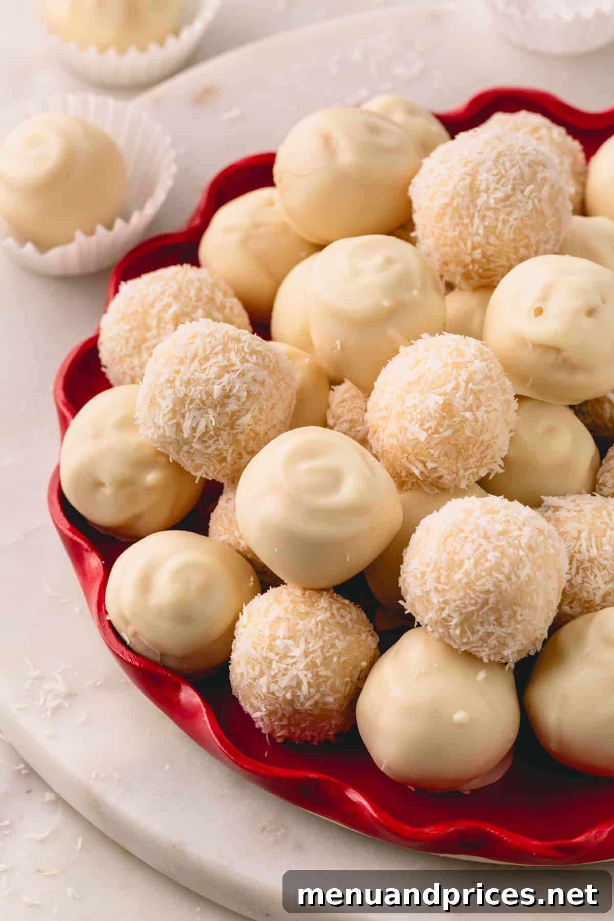 Almond Coconut Delights 2 A red platter with white chocolate coated and desiccated coconut coated almond coconut balls.