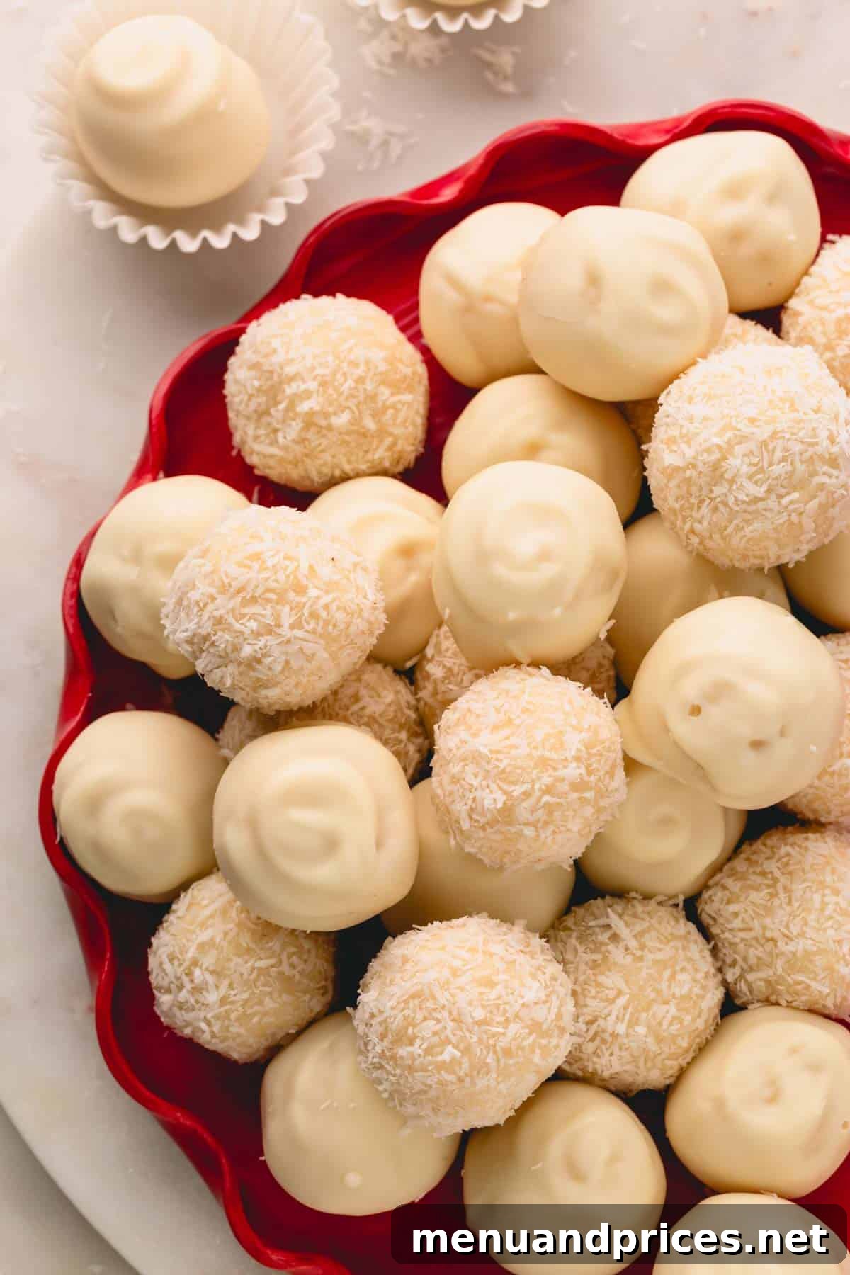 Almond Coconut Delights 15 A red platter with white chocolate covered and coconut covered almond coconut balls.
