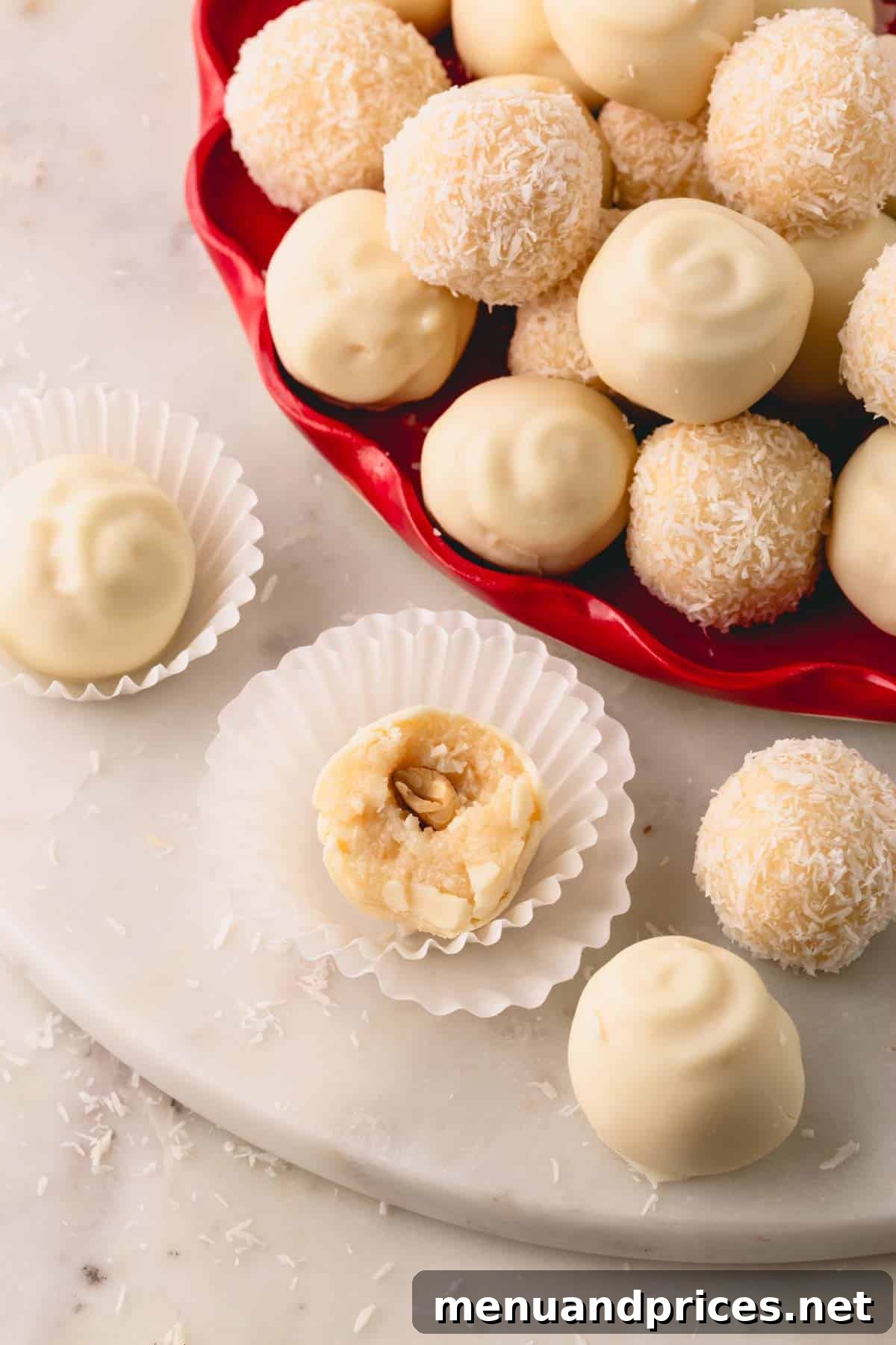 Almond Coconut Delights 16 Coconut almond balls, some coated in white chocolate and others with desiccated coconut.