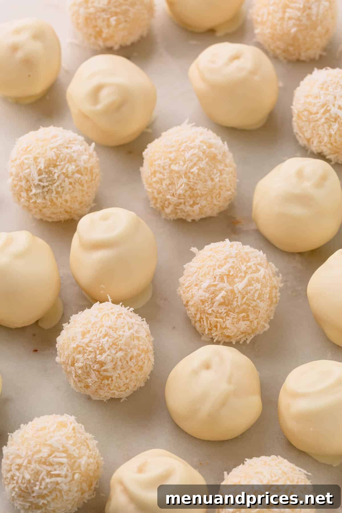 Almond Coconut Delights 3 Coconut balls coated with white chocolate and others covered with desiccated coconut.