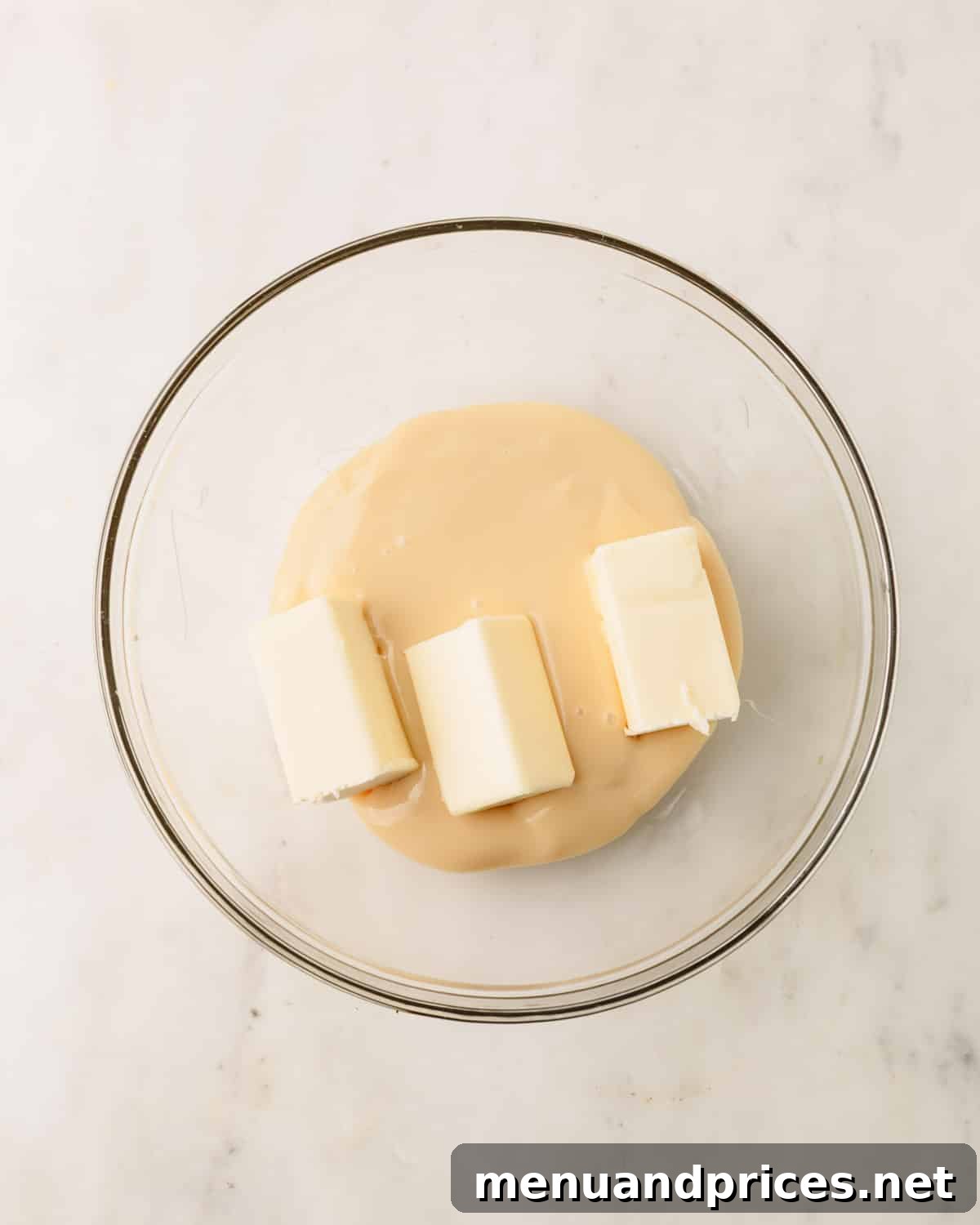 Almond Coconut Delights 5 A bowl of condensed milk with butter on top.