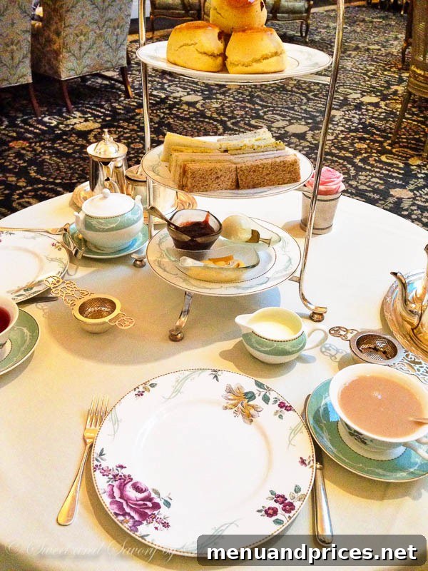 London Visual Diary 26 The elegant setting of Afternoon Tea at The Savoy's Thames Foyer, featuring exquisite pastries and tea.