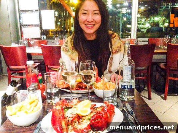 London Visual Diary 9 A happy traveler enjoying a delicious whole grilled lobster with chips at Fish! in Borough Market, London.