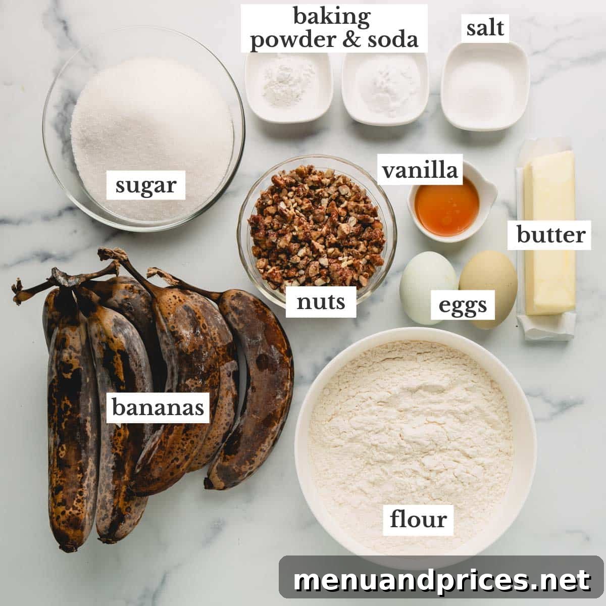A collection of fresh ingredients laid out on a wooden surface, including ripe bananas, flour, sugar, butter, and eggs, ready for baking banana bread.