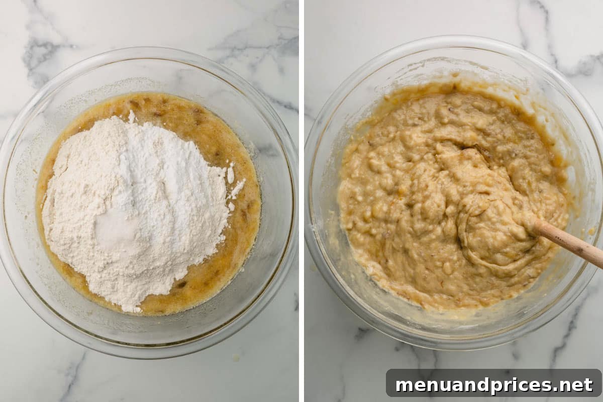 Dry ingredients being gently stirred into a bowl of banana bread batter with a wooden spoon, creating a smooth mixture.