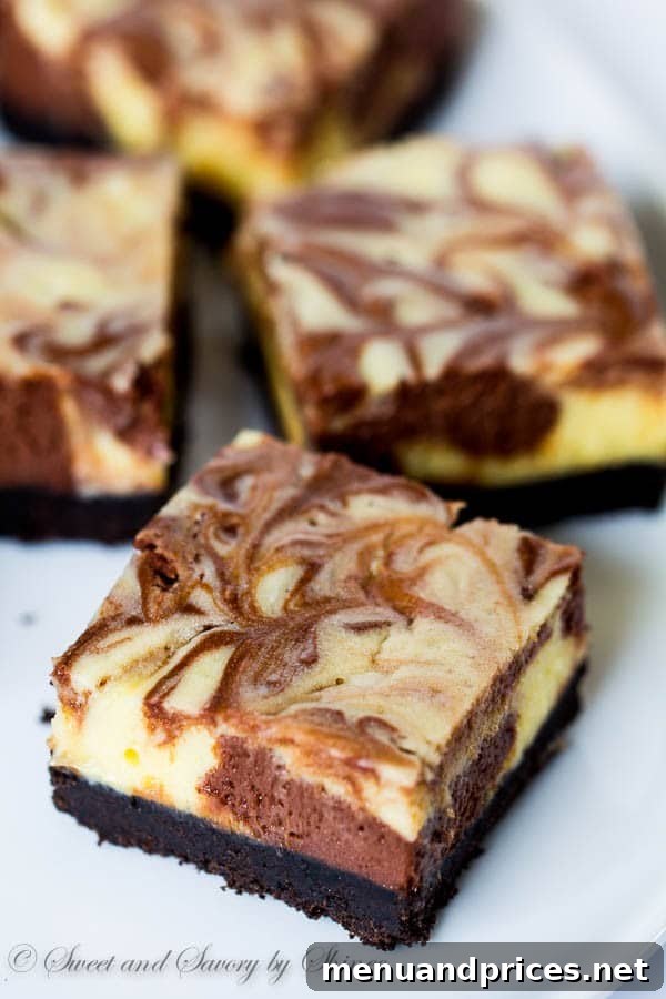 Decadent Three-Chocolate Cheesecake Squares 3 Beautifully swirled triple chocolate cheesecake bars, showcasing the contrast between dark and white chocolate layers.