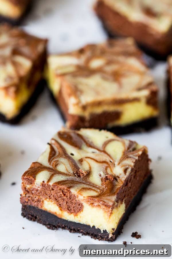 Decadent Three-Chocolate Cheesecake Squares 5 Finished triple chocolate cheesecake bars, perfectly sliced and ready to be served, highlighting the vibrant swirls.