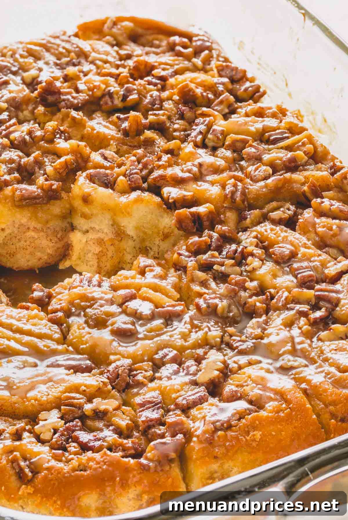 Irresistible Caramel Rolls 2 Overnight caramel rolls in a baking dish with a center roll missing.