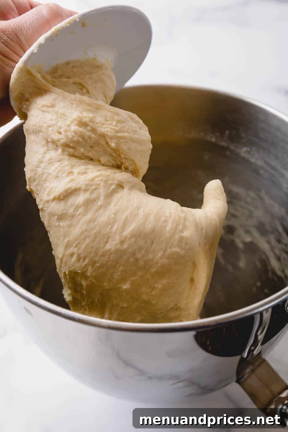 Irresistible Caramel Rolls 7 Caramel roll dough on a dough hook.