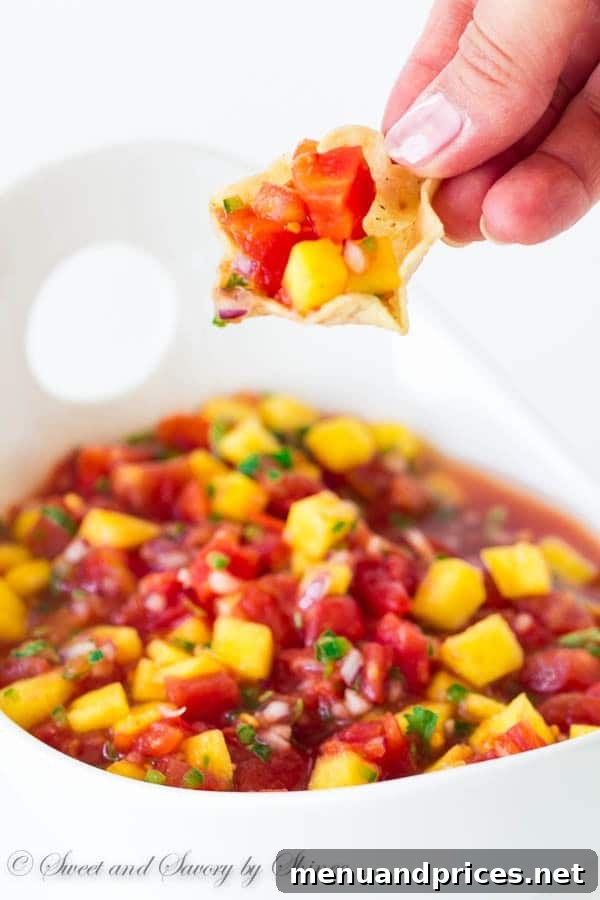 Sweet Heat Mango Relish 8 Mango salsa served in a bowl with tortilla chips, ready to eat