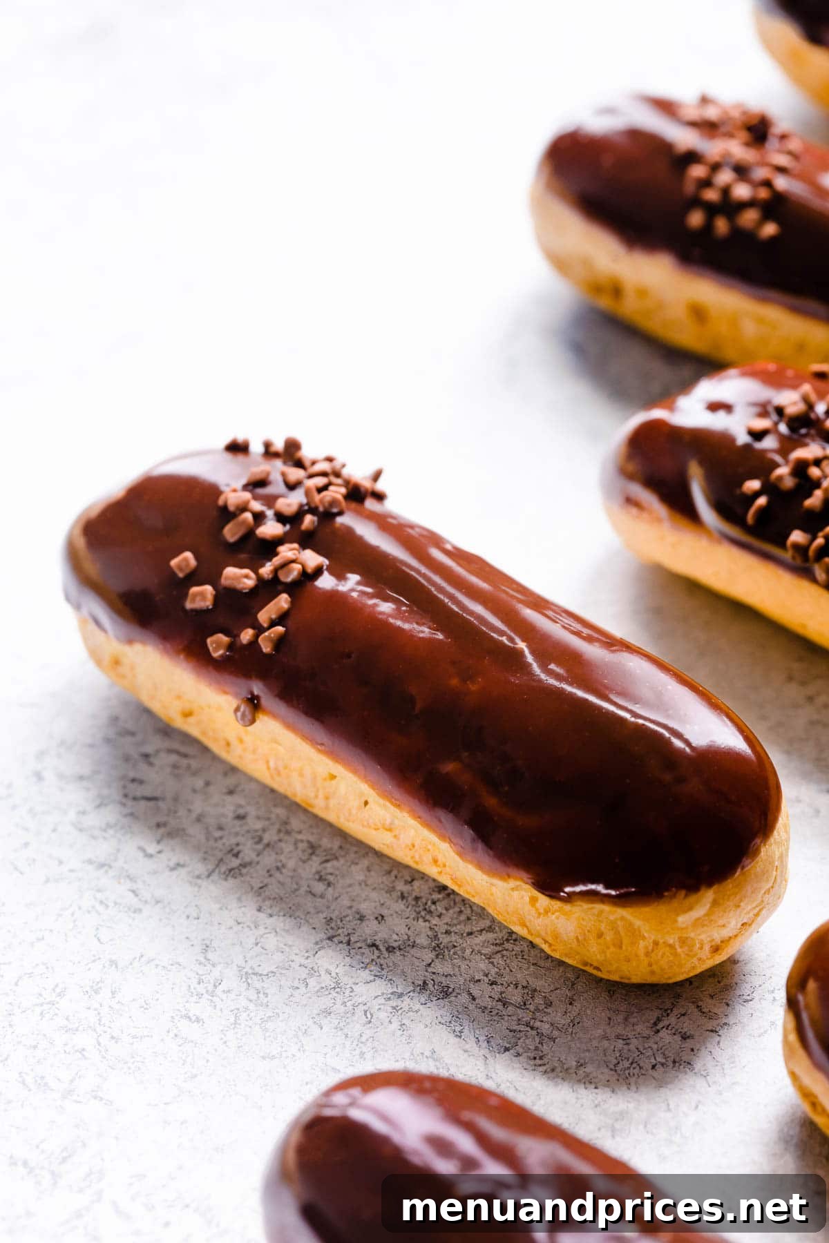 Divine Chocolate Eclairs 2 Upclose shot of chocolate eclair, showcasing its perfect glaze and golden-brown shell.