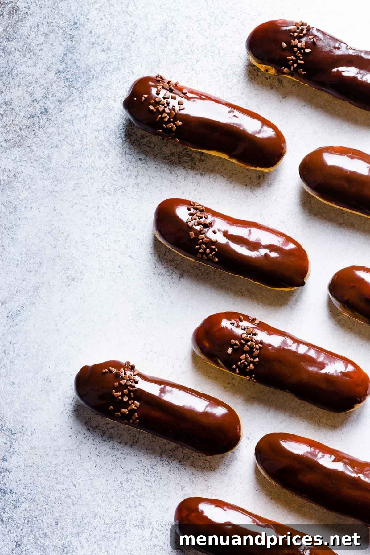 Divine Chocolate Eclairs 13 Overhead shot of freshly baked chocolate eclairs on a cooling rack.