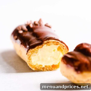 Divine Chocolate Eclairs 14 Sliced chocolate eclair filled with pastry cream, ready to be enjoyed.