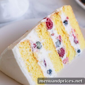 A beautifully decorated Berry Chantilly Cake, showcasing its vibrant fresh berries and creamy frosting.