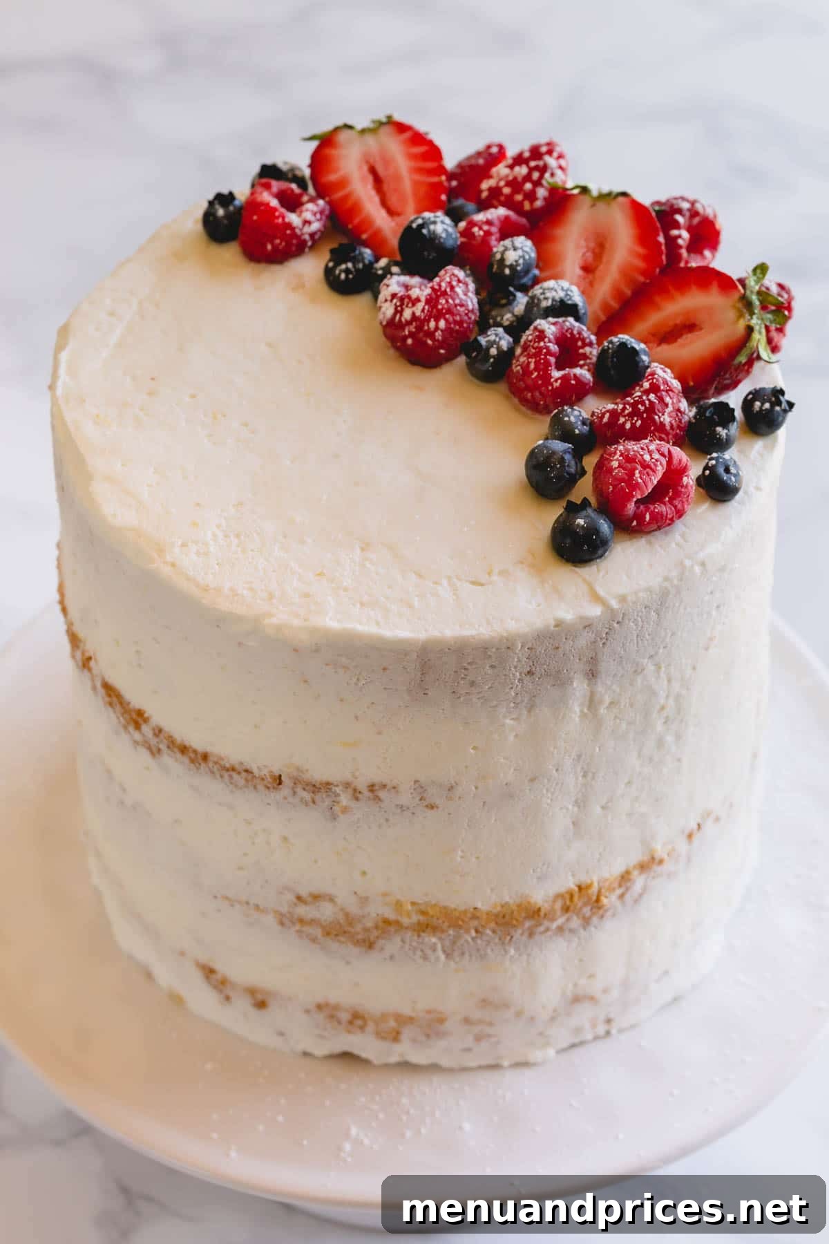Fresh Berry Chantilly Delight 4 A beautifully sliced 4-layer Berry Chantilly cake, revealing its delicate layers of sponge, cream, and berries, on a stand.