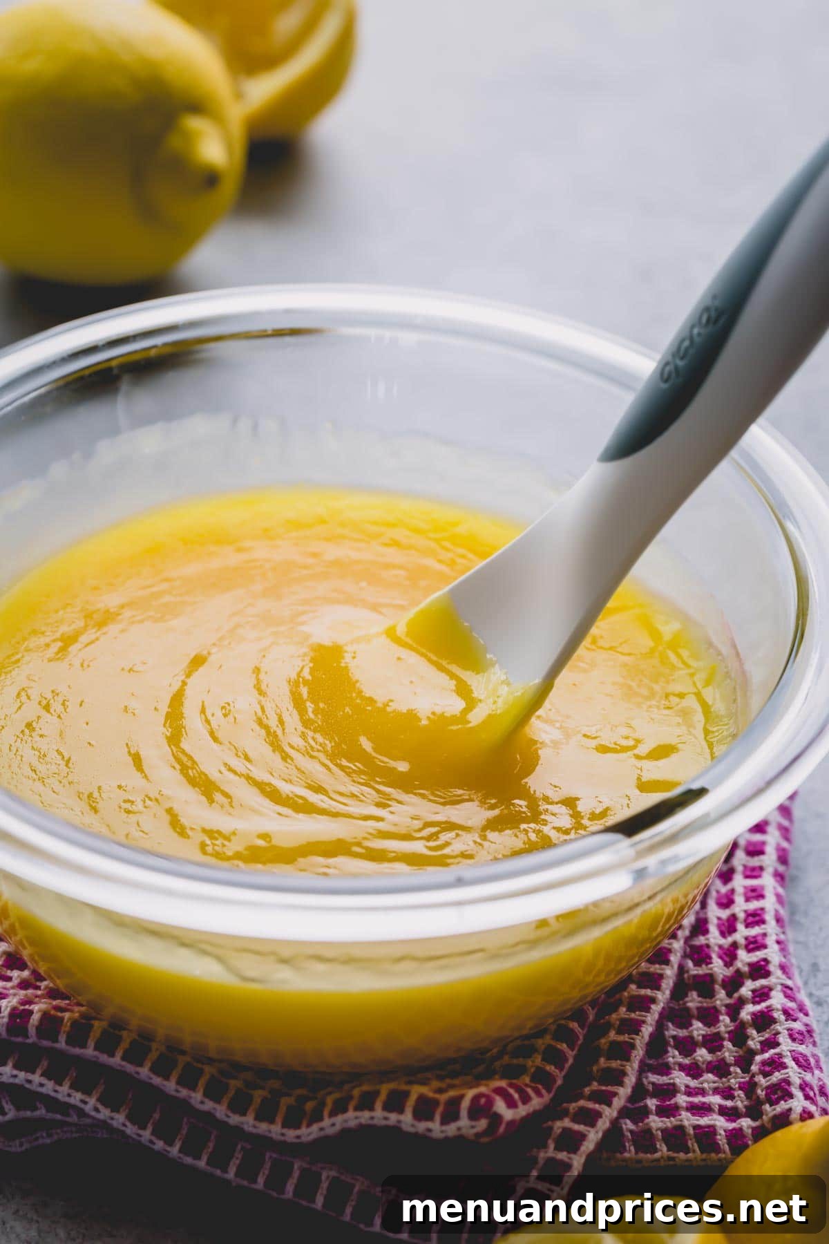 Homemade lemon curd glistening in a beautiful glass bowl.