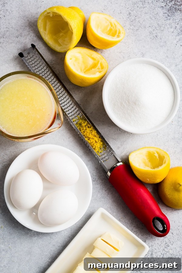 A beautiful flat lay of simple ingredients for delicious homemade lemon curd, including lemons, eggs, sugar, and butter.