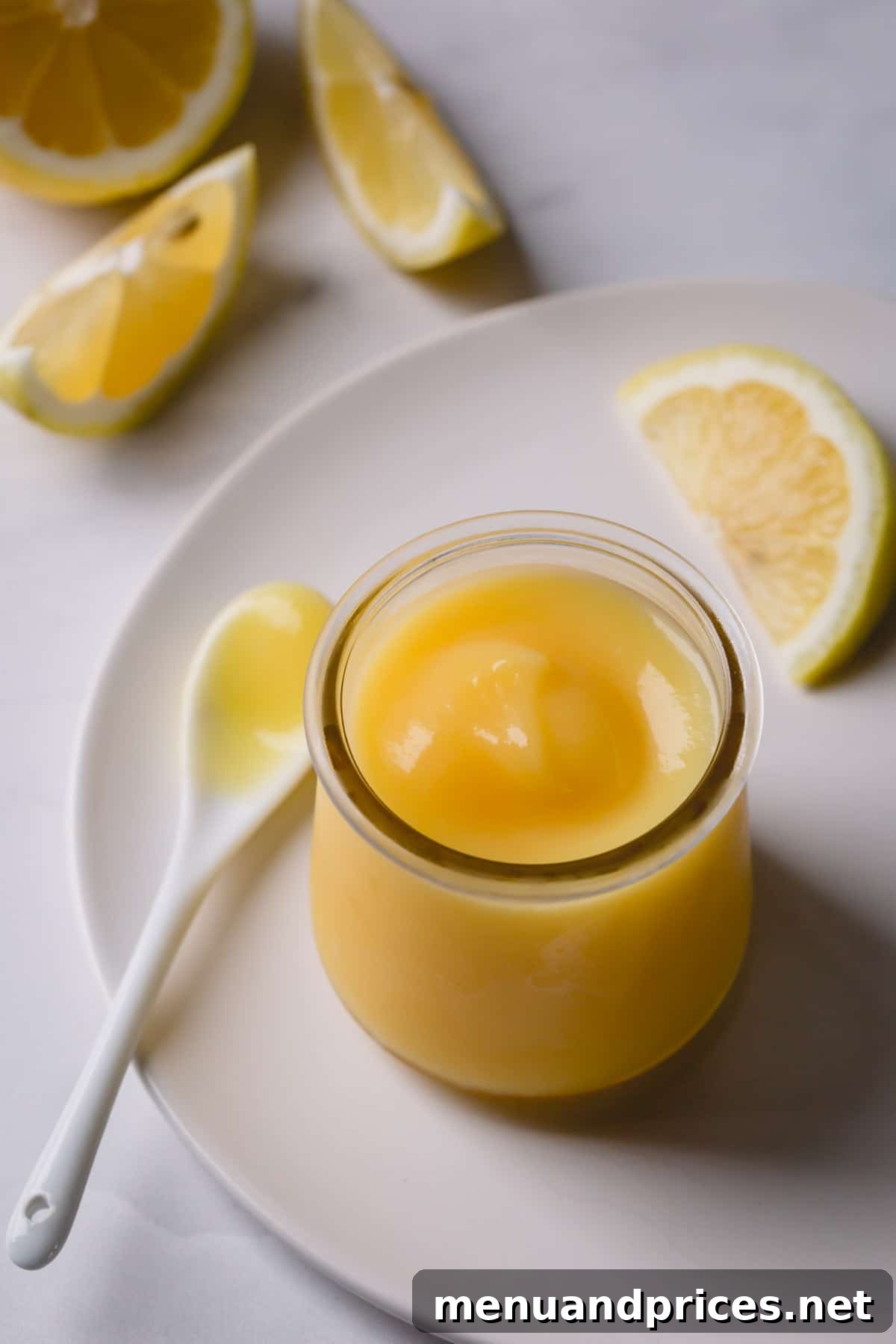 Perfectly creamy lemon curd presented in an elegant glass jar.