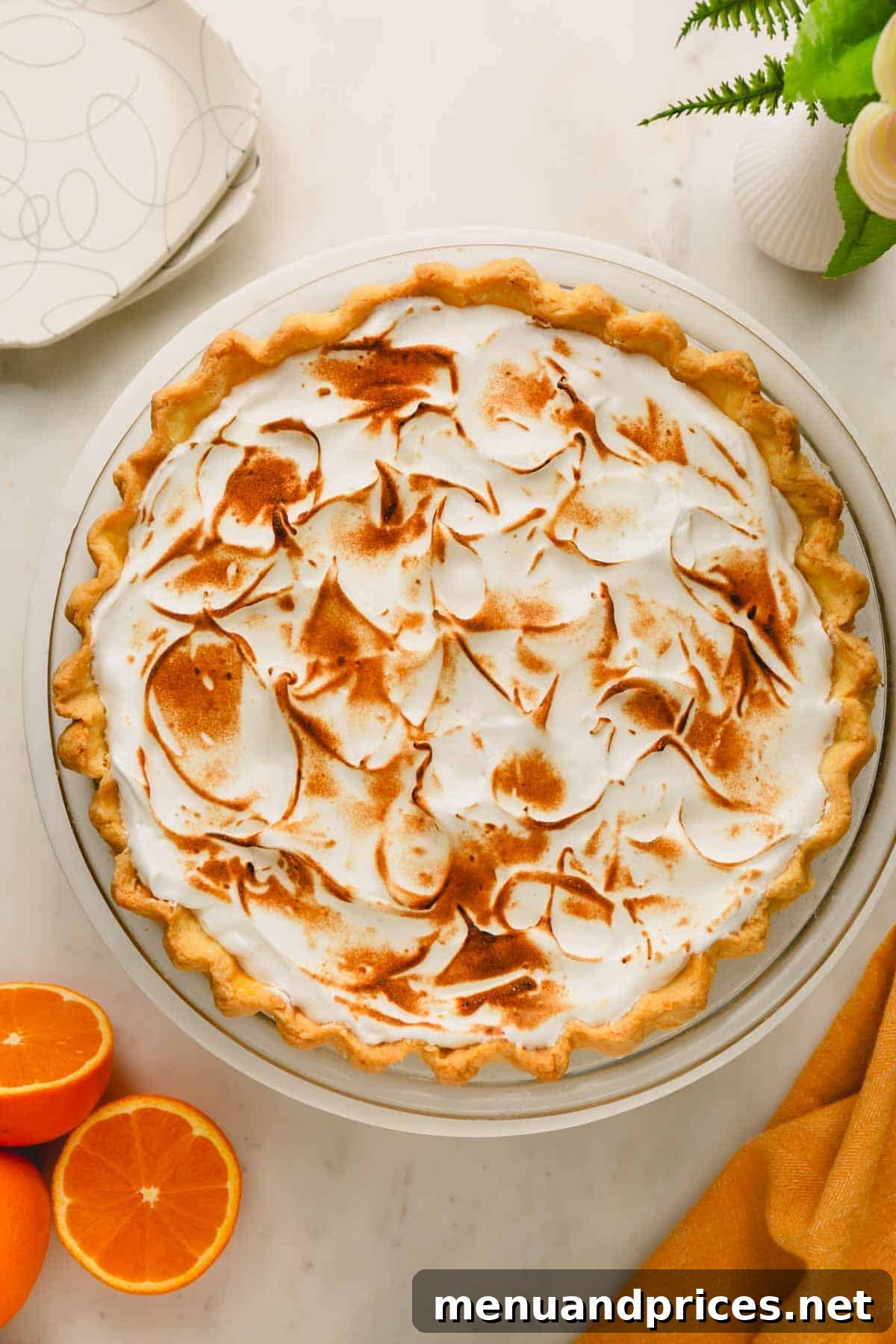 Zesty Orange Cloud Pie 3 An orange meringue pie with a beautifully toasted, fluffy meringue topping, ready to be served.