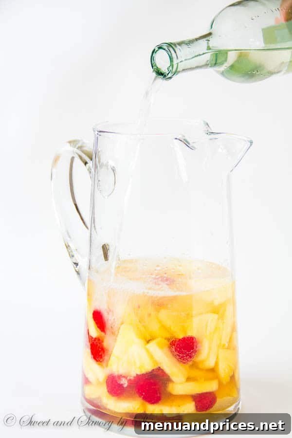 Glass of Pineapple Raspberry Sangria garnished with fresh fruit