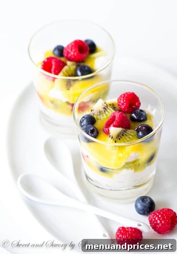 Whipped Lemon Delight 4 Three individual Lemon Chantilly Parfaits artfully presented in clear glasses, topped with raspberries, blueberries, and kiwi slices