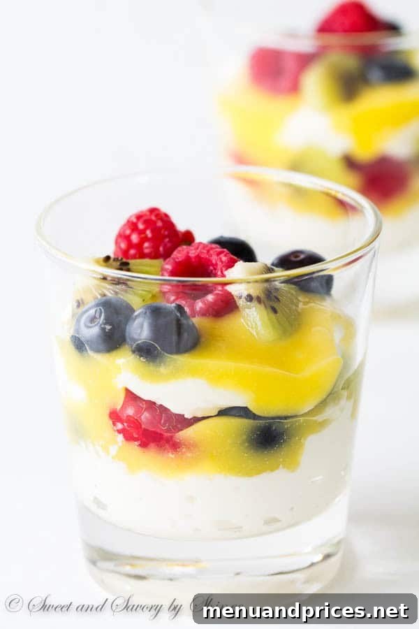 Whipped Lemon Delight 6 Close-up of a beautifully assembled Lemon Chantilly Parfait, showcasing fluffy cream, golden lemon curd, and colorful fresh fruits