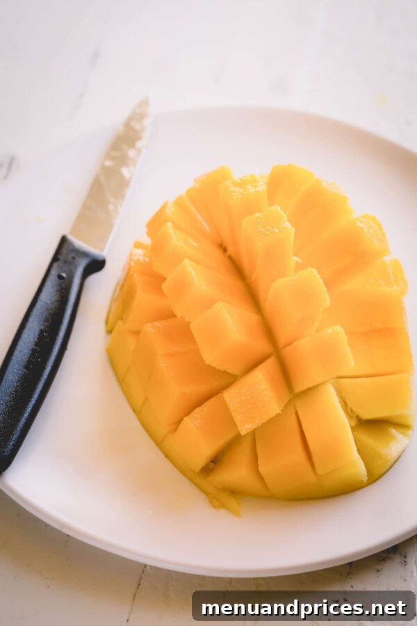 Tropical Mango Cucumber Medley 4 A mango half expertly sliced into a grid pattern, showcasing the method for easy cubing.