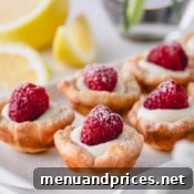 A smaller image of raspberry lemon tartlets arranged on a rectangular serving platter.