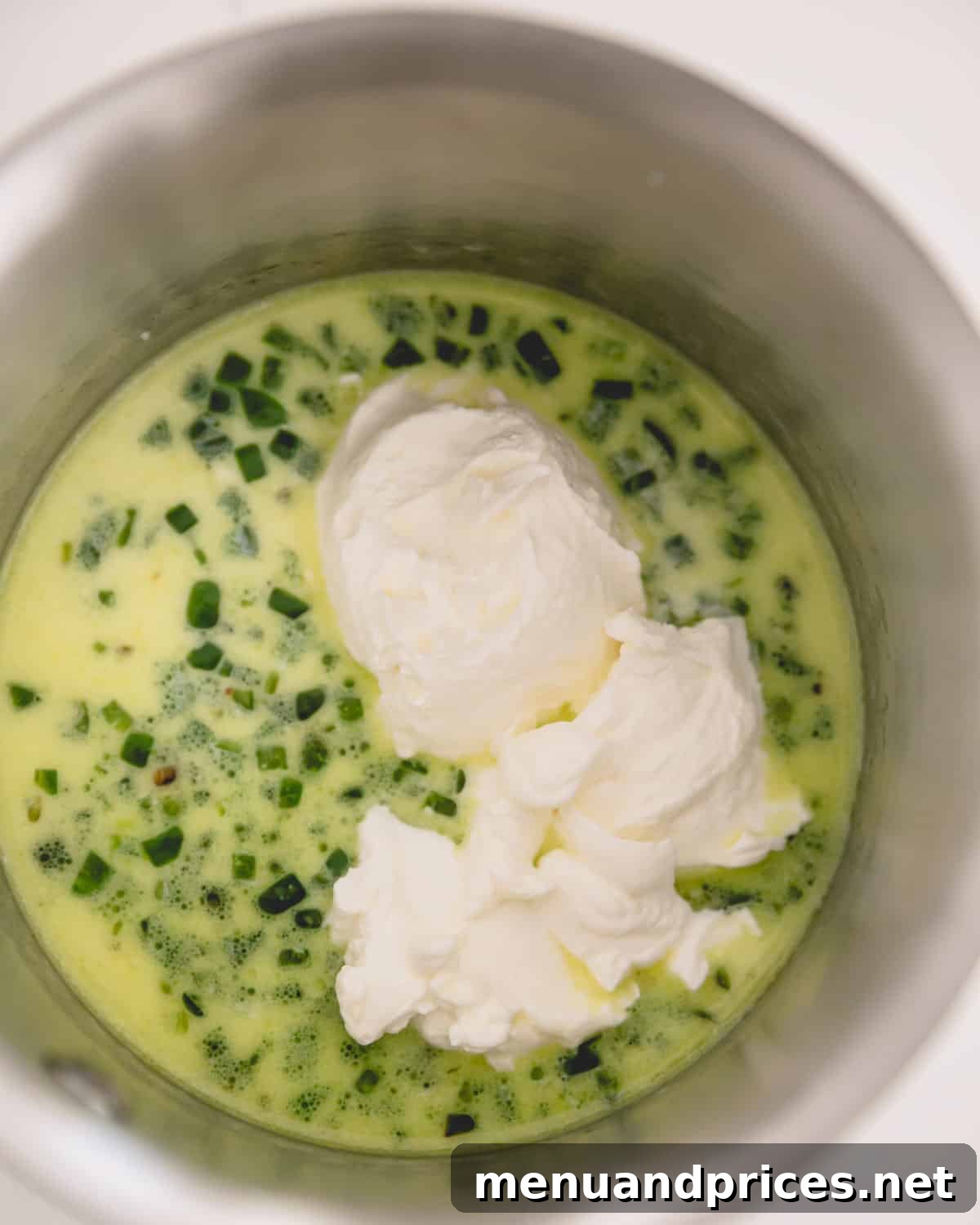 Cheddar Jalapeno Dip 8 A saucepan with jalapeno, milk, and sour cream.