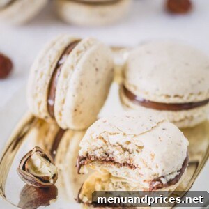 Close-up of a beautifully assembled chocolate hazelnut macaron with Nutella filling.