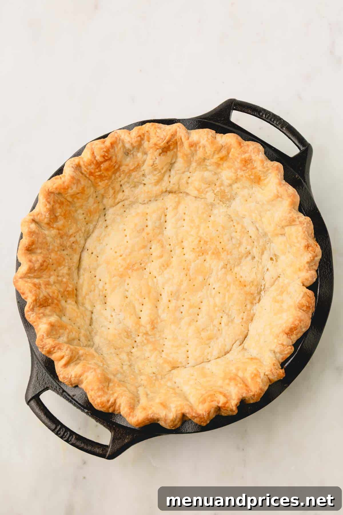 Pure Butter Flaky Pie Pastry 11 A perfectly blind-baked golden-brown pie crust resting in a classic pie dish, ready for filling.