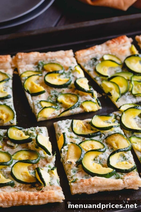 Summer Zucchini Ricotta Tart 4 A close-up of a zucchini ricotta tart, freshly sliced to reveal the creamy filling and tender zucchini.
