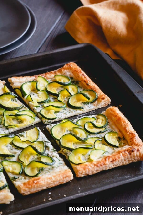 Summer Zucchini Ricotta Tart 5 Several slices of zucchini ricotta tart arranged artfully on a white serving plate.