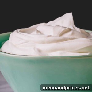 A large bowl of homemade yogurt whipped cream ready to be served, a close-up.