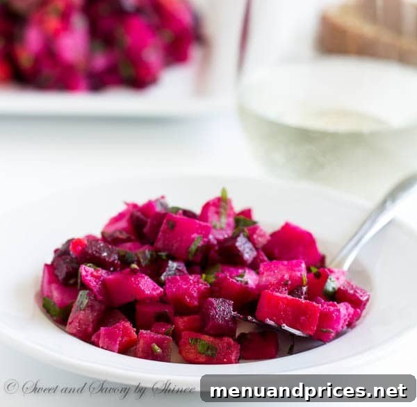 Vibrant Russian Root Vegetable Salad 6 Close-up of classic Russian vinaigrette salad (Винегрет) with roasted beets, potatoes, carrots, and pickles, showcasing its vibrant colors and texture, dressed in simple extra virgin olive oil.