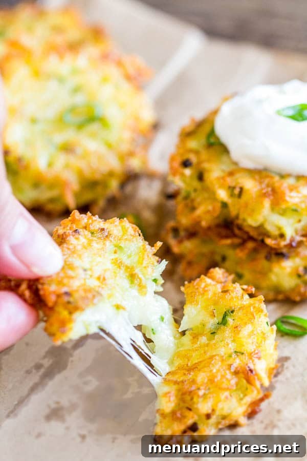 Golden Cheesy Potato Fritters 5 Gooey Cheesy Potato Pancakes with Sour Cream Garnish