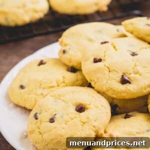 A plate full of golden-brown chocolate chip cookies, indicating their soft and chewy texture.