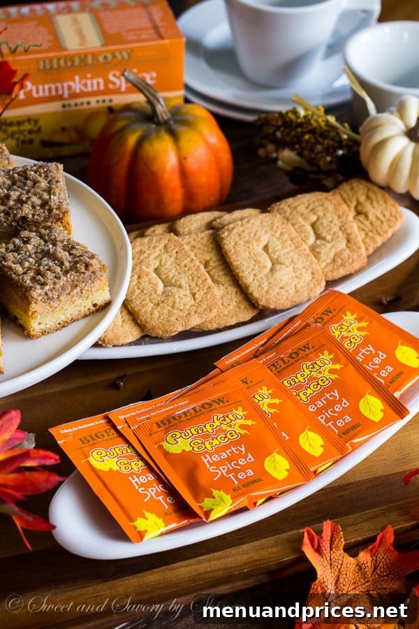 Autumn Spice Tea Gathering 2 A cozy scene with a hand holding a cup of pumpkin spice tea, surrounded by autumn leaves and a warm, inviting atmosphere, perfect for relaxation and enjoying fall.