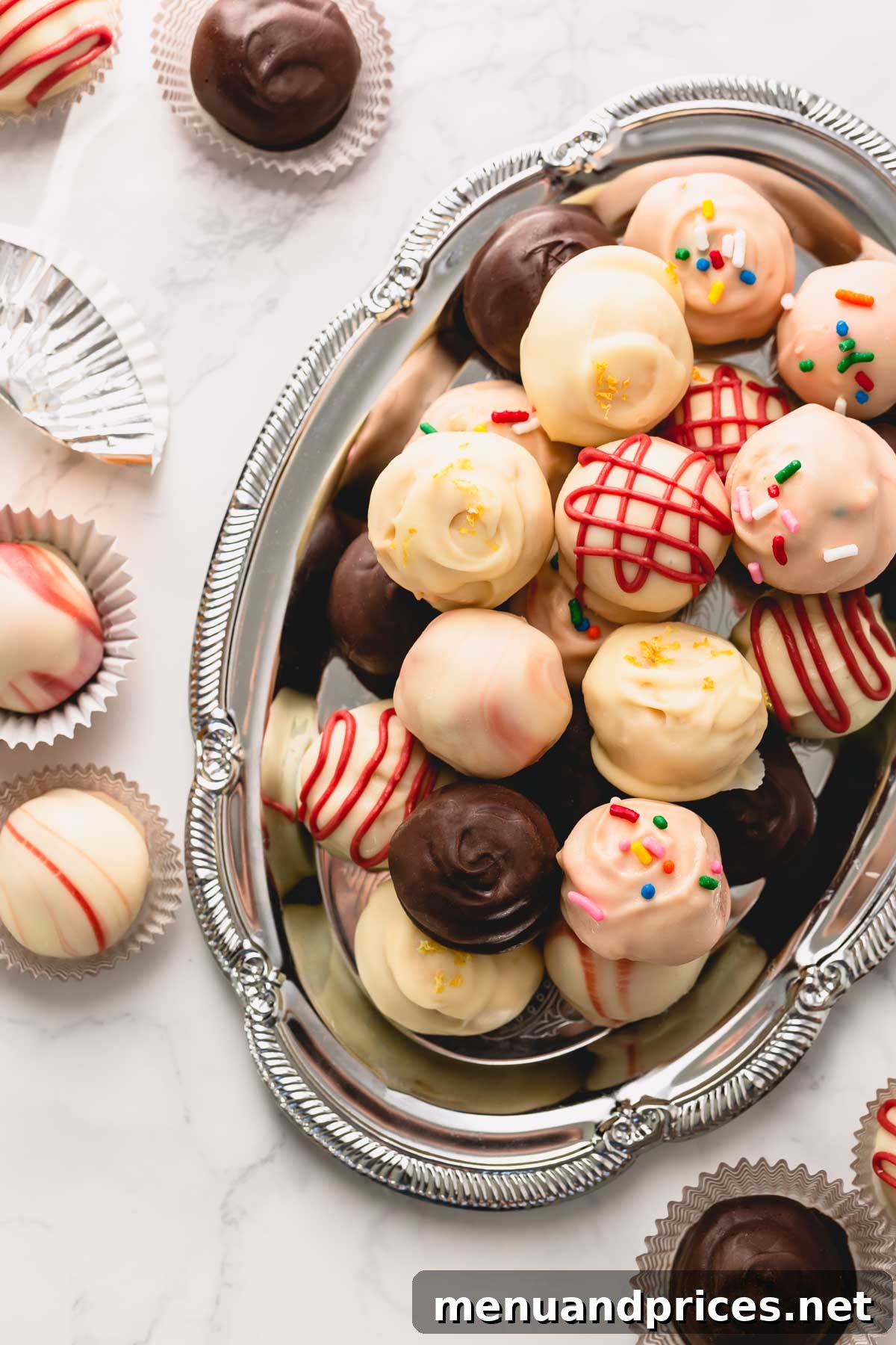 Colorful Oreo balls arranged on a festive silver serving platter.