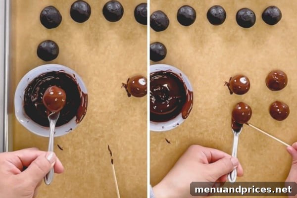 Dipping an Oreo ball in melted chocolate using a fork.