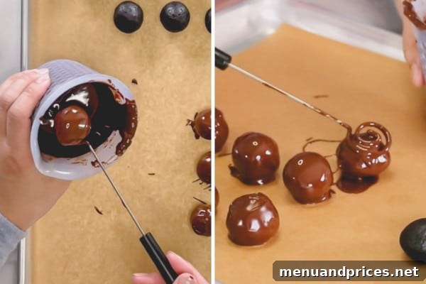 Dipping an Oreo ball in chocolate using a specialized candy dipping tool.